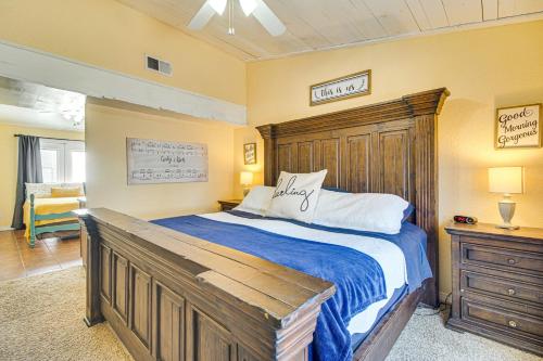 a bedroom with a large bed with a wooden headboard at Grove Lake House with Boat Dock and Outdoor Spots! in Grove