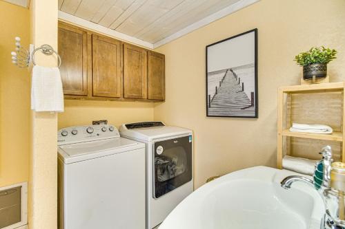 a small bathroom with a washing machine and a sink at Grove Lake House with Boat Dock and Outdoor Spots! in Grove