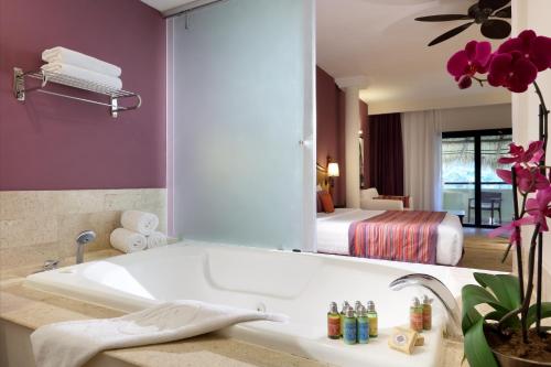 a bathroom with a tub and a bedroom with a bed at Grand Palladium Vallarta Resort & Spa - All Inclusive in Punta Mita