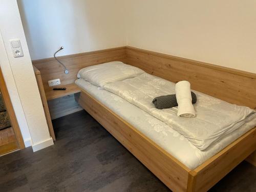 a wooden bed in a small room with at Landgasthof Zum Schwanen in Durach