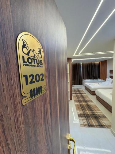 a hotel room with a sign on a wall at Lotus Pyramids & Jacuzzi in Cairo