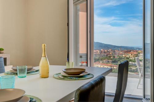 a dining room table with a view of a city at Terrazza Paradiso in Capoliveri