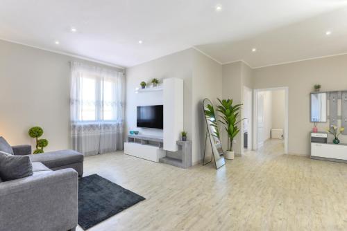 a living room with a couch and a tv at Terrazza Paradiso in Capoliveri