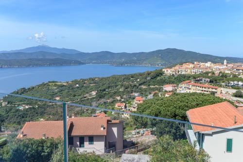 a view of a town with a lake in the background at Terrazza Paradiso in Capoliveri