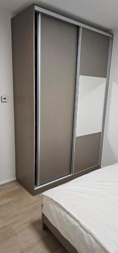 a bedroom with a large sliding glass door at Stan 7 in Loznica