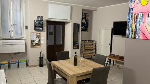 a kitchen with a table and a dining room at Appartamento Vacanze - Holiday Apartment "Ortamore" in Orta San Giulio