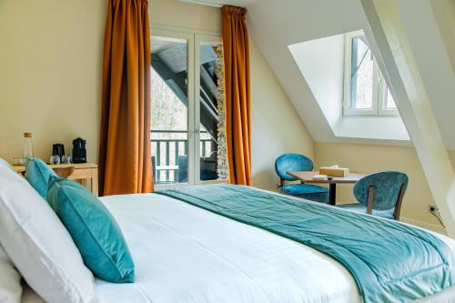 a bedroom with a bed and a window at Moulin de Cambelong- Emilie & Thomas in Conques-en-Rouergue