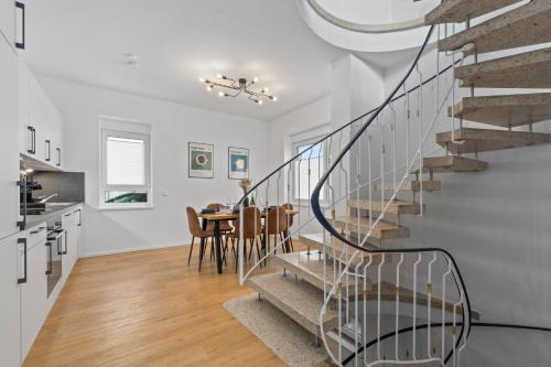 a kitchen and dining room with a spiral staircase in a house at Charmante Design-Apartments in Top Lage - Nähe Altstadt - Parkplätze - Netflix in Bad Kreuznach