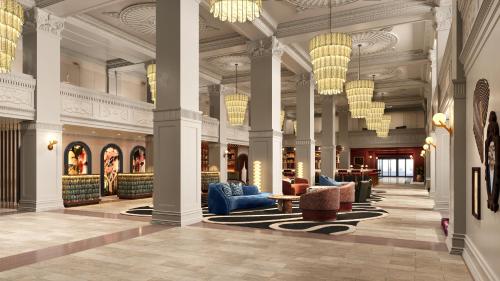 a lobby of a hotel with couches and chairs at The Gunter Hotel San Antonio Riverwalk in San Antonio