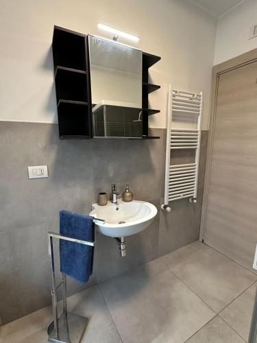 a bathroom with a sink and a mirror at Alloggio Nola - casa e box auto in Nola