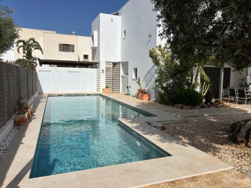 a swimming pool in front of a house at Villa Filon in Rodalquilar