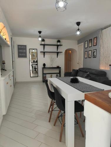 a kitchen and living room with a white table and chairs at Casa Ginietta in Positano