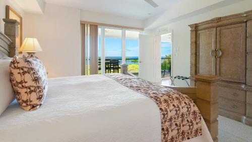 a bedroom with a large bed and a view of the ocean at 523 Mariners Club in Key Largo