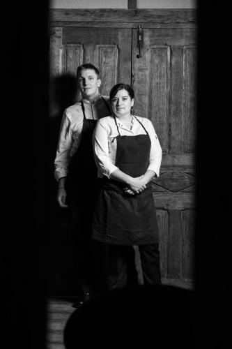 a man and a woman standing in front of a door at Moulin de Cambelong- Emilie & Thomas in Conques-en-Rouergue