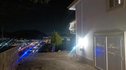 a building with a view of a city at night at Relais Tiaré Bed and Breakfast in Bacoli