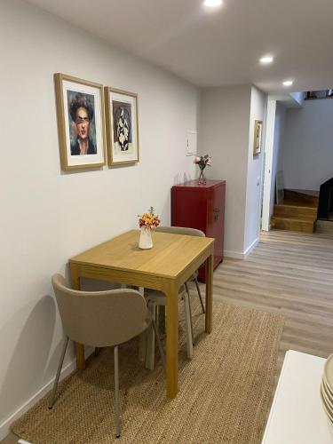 a dining room with a wooden table and chairs at Daisy Street Guesthouse in Braga