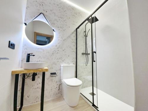 a bathroom with a toilet and a sink and a mirror at Apartamento Flower Deluxe 6081 in Noja