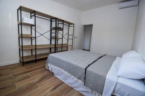 a bedroom with a bed and a wooden floor at Sweetstaybykw Moderna Casa Campo con Piscina in Asprillas