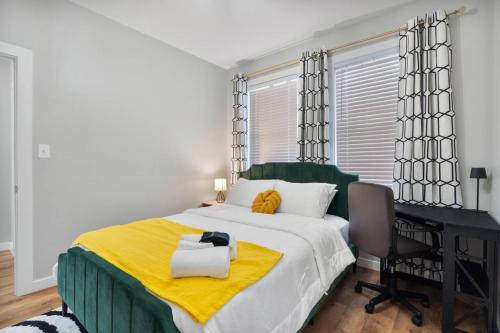 a bedroom with a bed with a desk and a computer at Comfy Room Downtown Indy in Indianapolis