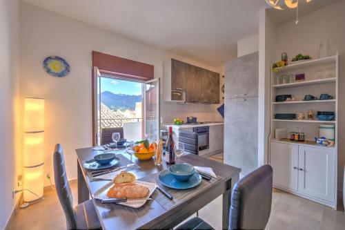 a kitchen and dining room with a table and chairs at Sicilian Charm close to Taormina - Happy Rentals in Gaggi