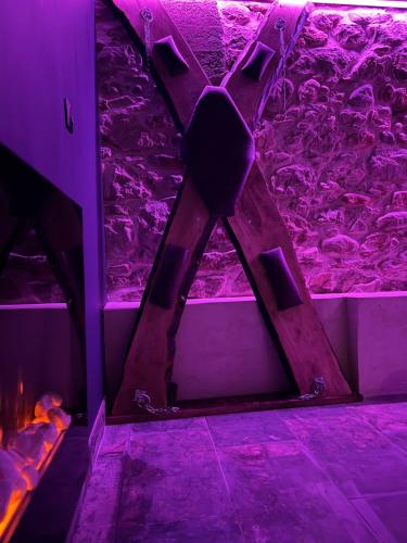 a room with purple lights on the floor at L'instant plaisir in Bettant