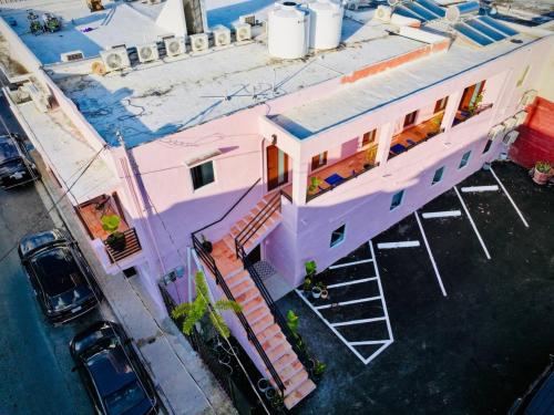 an overhead view of a pink house with a parking lot at Room 16 Grand King Suite with Desk & Sofa Bed in San Juan