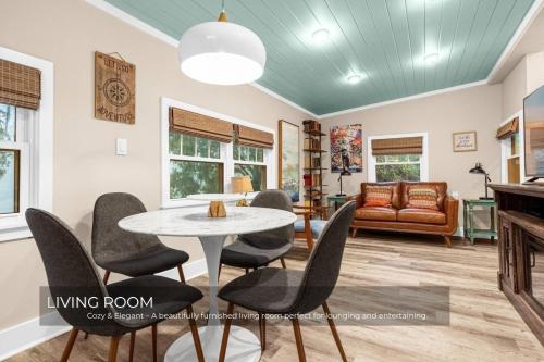 a living room with a table and chairs at Mills Cottage in Orlando