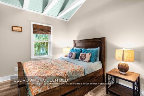 a bedroom with a bed and a table and a window at Mills Cottage in Orlando