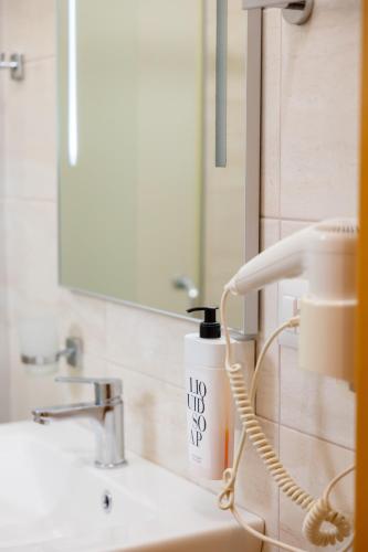 a bathroom sink with a blow dryer on the counter at Sofo Hotel Dhermi in Dhërmi