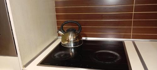 a tea kettle sitting on top of a stove in a kitchen at Sevasti in Perea