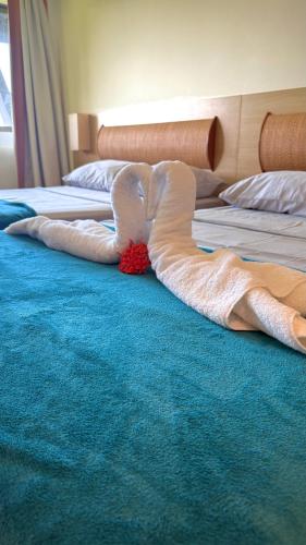 a pair of white mermaid sheets on a bed at Beach class muro alto in Porto De Galinhas