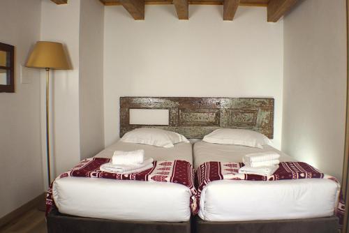 a bed with two pillows on it in a room at Casal do Amor in Lousã