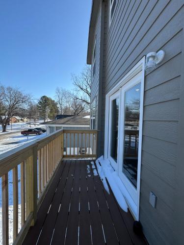 a wooden deck with a window on the side of a house at Newly built 3 level home 2 minute drive to UCM in Warrensburg