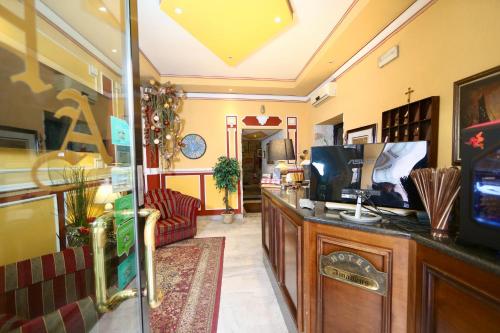 a lobby of a store with a tv on a counter at Hotel Amadeus in Caserta