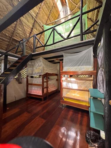 two bunk beds in a room with wooden floors at Finca Tatin Hotel in Lámpara