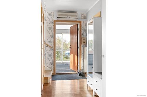 a hallway with a door leading into a room at Lakefront house on Skåne's largest island in Ivö