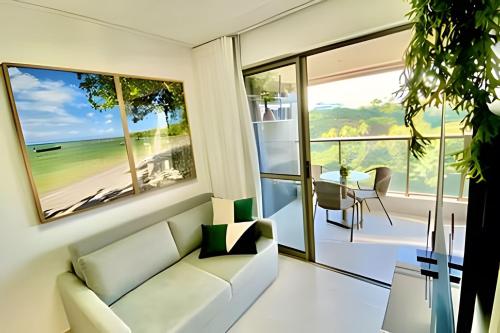 a living room with a couch and a view of the ocean at Capitães de Areia in Salvador