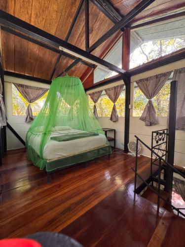 a bedroom with a bed in a room with wooden floors at Finca Tatin Hotel in Lámpara