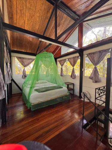 a bed in a tent in a room at Finca Tatin Hotel in Lámpara
