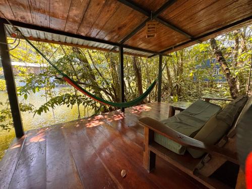 a hammock on the deck of a boat at Finca Tatin Hotel in Lámpara