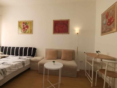 a living room with a couch and a table at Sunbeams Studio Unit in Lapu Lapu City