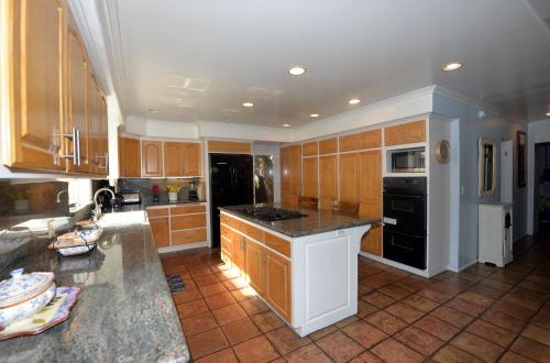 a kitchen with wooden cabinets and a counter top at 211CL 211 Claressa in Avalon