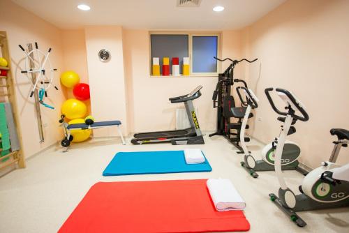 a gym with several exercise equipment in a room at Hotel TTS**** Spa&Wellness Covasna in Covasna