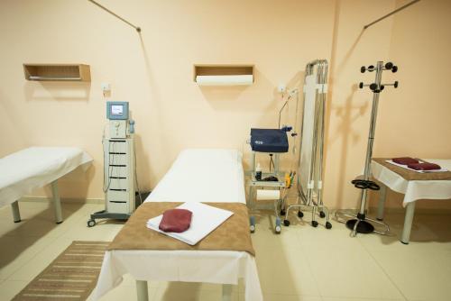 a hospital room with two beds in a room at Hotel TTS**** Spa&Wellness Covasna in Covasna
