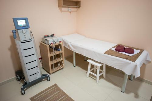 a hospital room with a bed and a monitor at Hotel TTS**** Spa&Wellness Covasna in Covasna