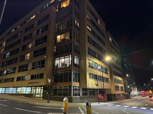 a large building on a city street at night at Harrow Town Centre Apartment in Harrow