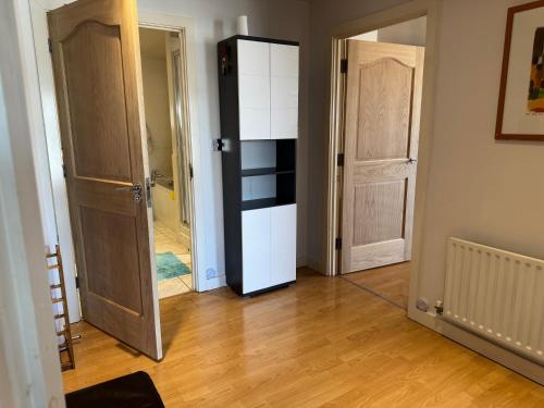 a room with two open doors and a hallway at Harrow Town Centre Apartment in Harrow