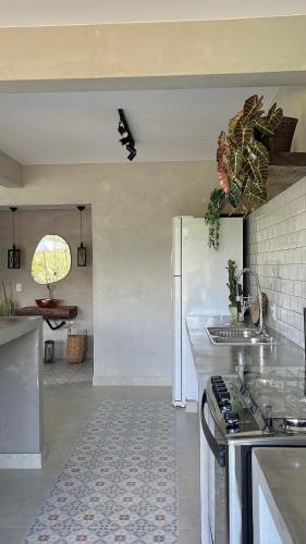 a kitchen with a stove and a refrigerator at Chalé Vista Azul in Domingos Martins