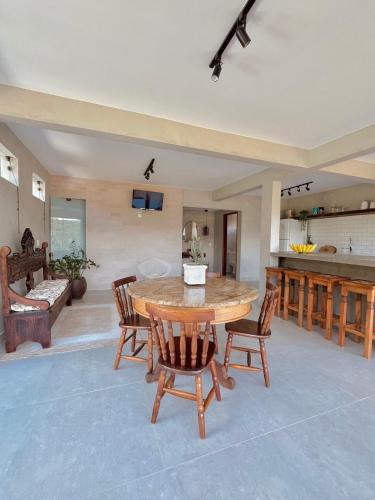 a large living room with a wooden table and chairs at Chalé Vista Azul in Domingos Martins
