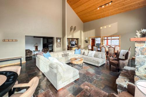 a living room with couches and a stone fireplace at Cozy Rustic Escape in Park City